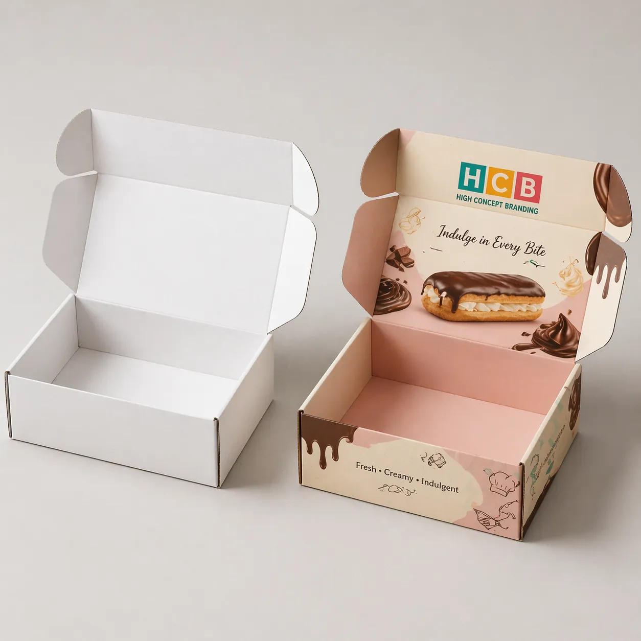 Two sturdy white cardboard boxes designed for the safe transport of delicate chocolate éclairs. class=